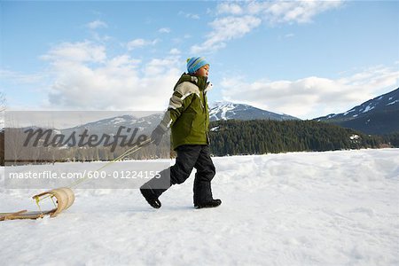 Boy Pulling Toboggan, Whistler, British Columbia, Canada