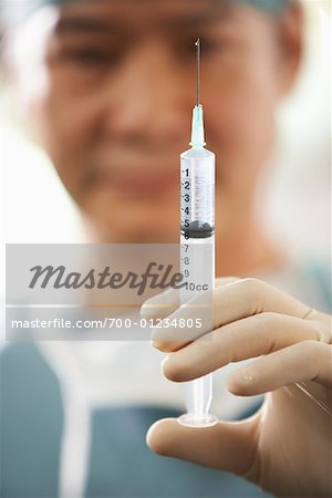 Doctor Holding Needle