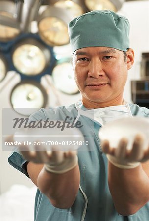Doctor Holding Implants