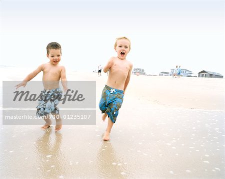 Boys Running at Beach