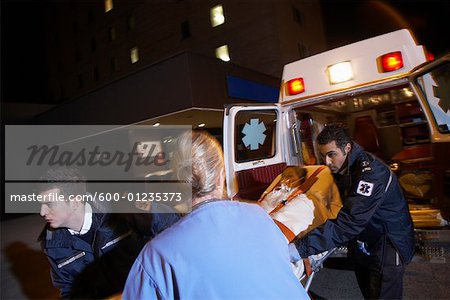 Doctor and Paramedics Removing Patient from Ambulance