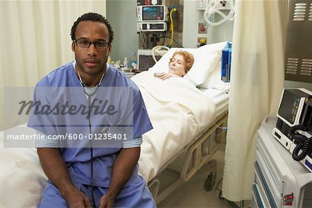 Doctor Sitting on Patient's Bed