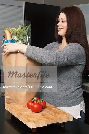 Woman Removing Groceries from Bag