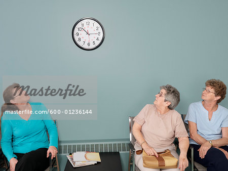 Patients in Waiting Room, Looking at Clock