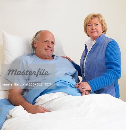 Woman with Sick Man in Hospital Room
