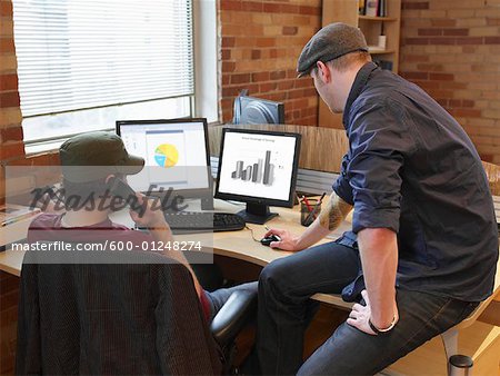 Men Looking at Graphs on Computer