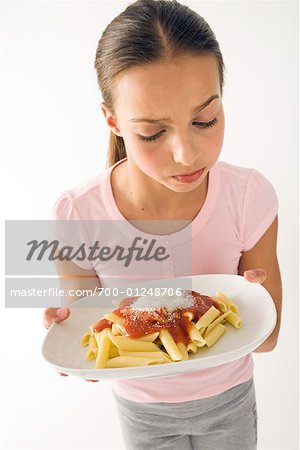 Girl Holding Plate of Pasta