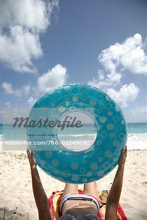 Woman on Beach with Inner Tube