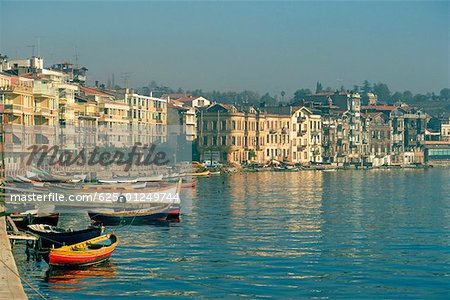 Boats moored at a harbor with buildings in the waterfront, Istanbul, Turkey