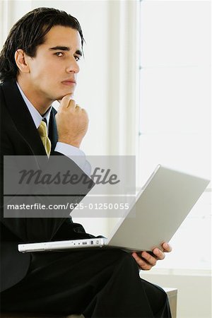 Side profile of a businessman with a laptop