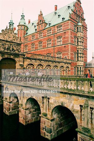 Group of people on the bridge in front of a castle, Frederiksborg Castle, Hillerod, Denmark