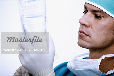 Close-up of a surgeon holding a saline drip