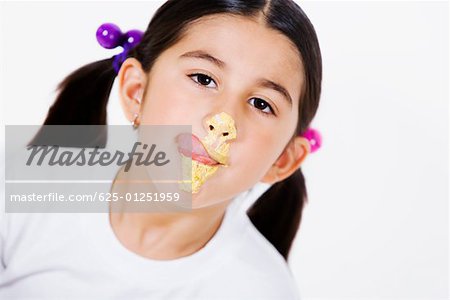 Portrait of a girl licking cream on her face