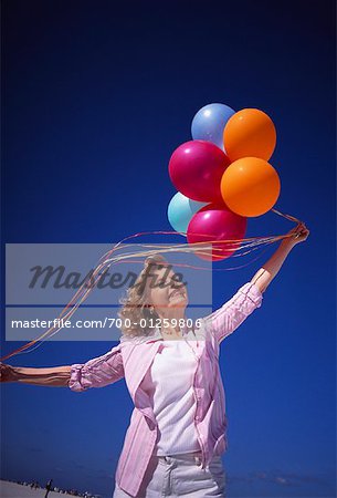 Senior Woman Holding Balloons