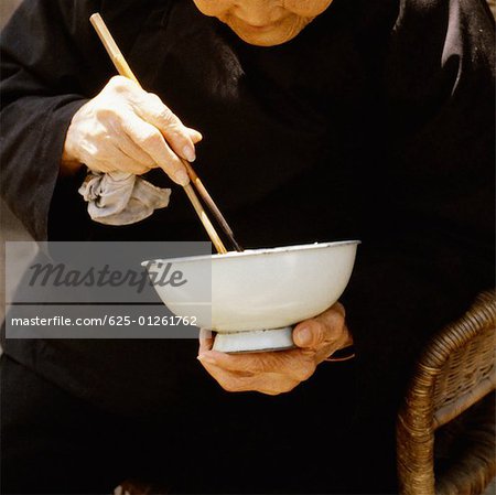 Nahaufnahme eines leitenden Menschen Essen mit Stäbchen, Xian, China