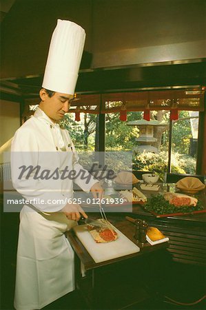 Chef preparing food in hotel kitchen, Tokyo Prefecture, Japan