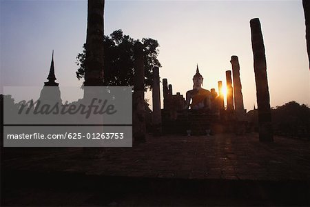 Silhouette of a statue of Buddha in a temple, Wat Mahathat, Sukhothai Historical Park, Sukhothai, Thailand