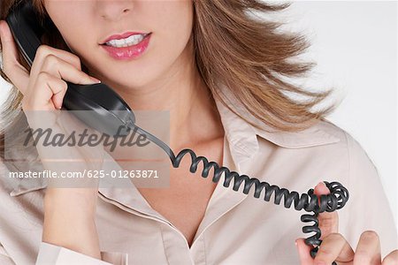 Mid section view of a businesswoman talking on the telephone