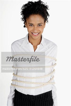 Portrait of a businesswoman tied up with rope and smiling