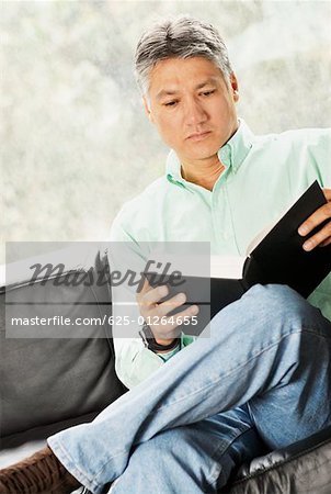 Close-up of a senior man reading a book