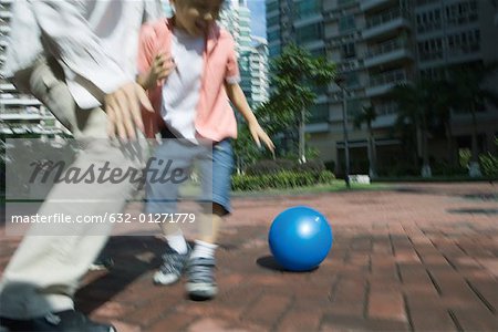 Father and son playing ball, blurred motion