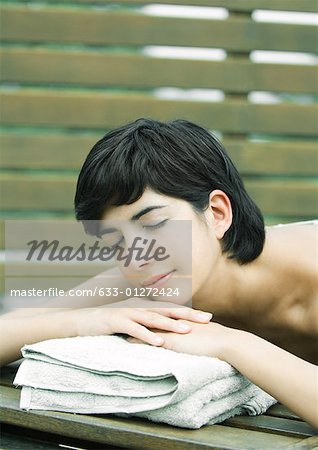 Woman lying on stomach, head on hands