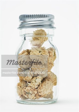 Bottle of dried chamomile flowers