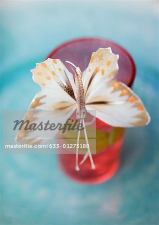 Fake butterfly on edge of glass