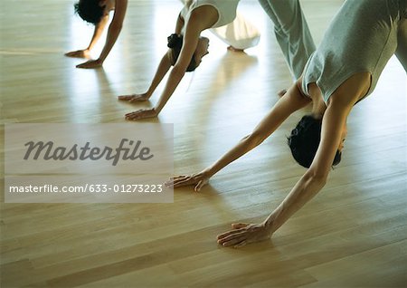 Yoga class in downward facing dog pose