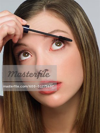 Young Woman Putting on Mascara