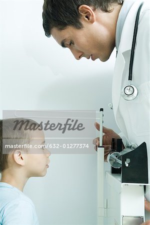 Doctor measuring boy's height