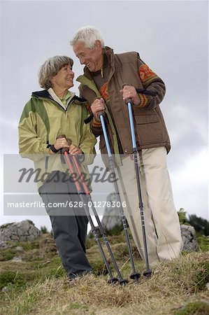 Senior adult couple hiking in the mountains, low angle view