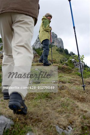Senior adult couple hiking in the mountains (part of), low angle view