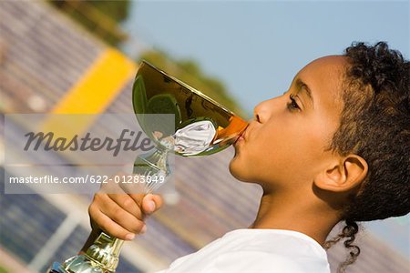 Boy kissing a trophy