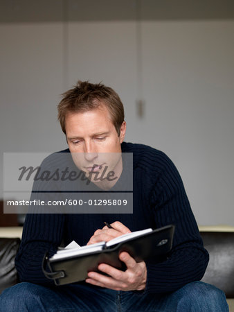 Man Looking at Appointment Book