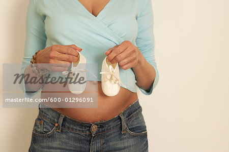 Woman Holding Baby Shoes