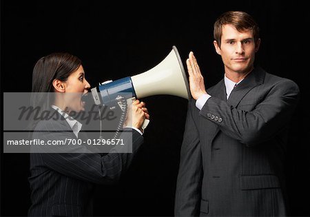 Businesswoman With Megaphone Yelling at Businessman