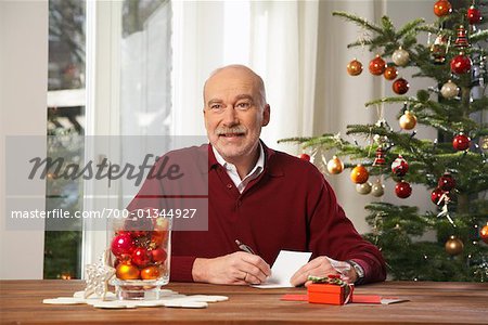 Man Writing in Christmas Card