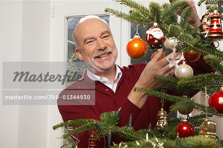 Man Decorating Christmas Tree