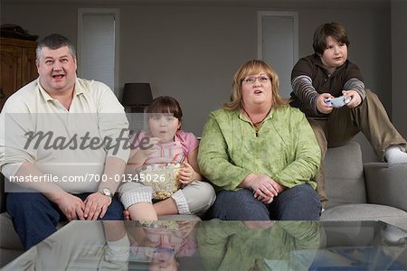 Family Playing Video Game with Popcorn