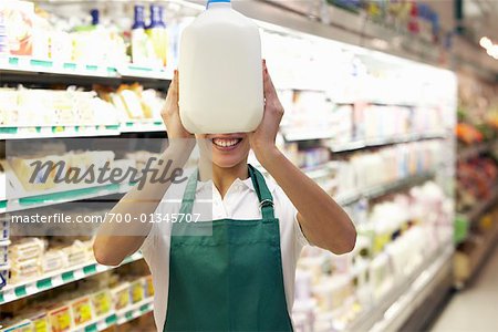 Grocery Clerk Holding Milk Jug
