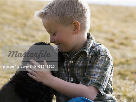 Boy with puppy outdoors