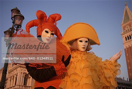 Portrait of two people in masquerade costumes