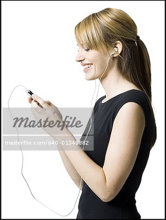 Profile of a young woman listening to an MP3 player