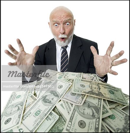 Close-up of a businessman looking at a pile of money