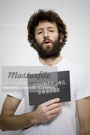 Man with beard holding blank sign