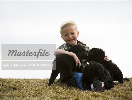 Boy with puppies outdoors