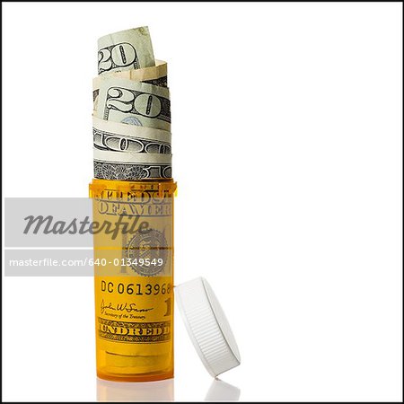 Prescription bottle filled with US currency