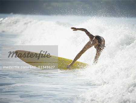 Young woman surfing on a surfboard