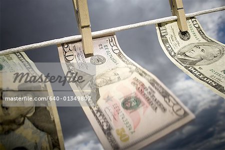 Close-up of American currency pegged to a clothesline